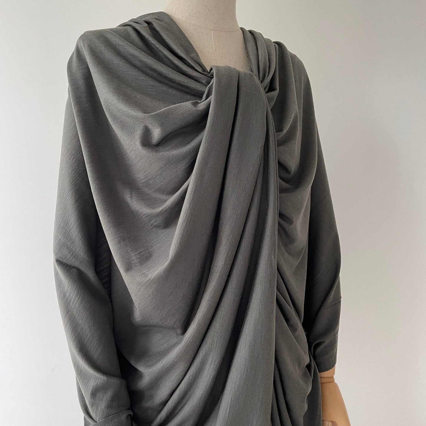 unedited image of merino wool fabric fashionably styled on dress form.