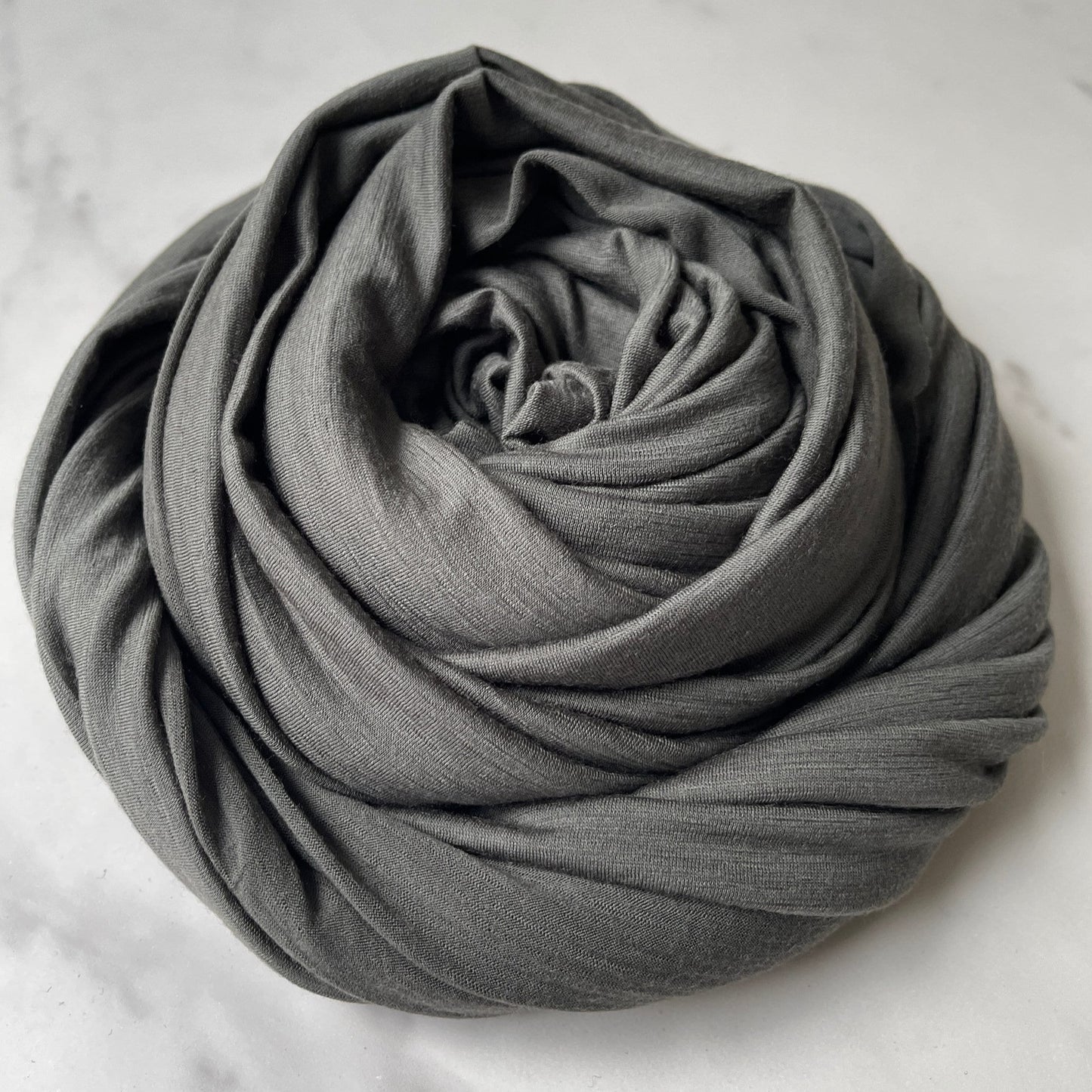 Stretch merino wool fabric under natural light source.