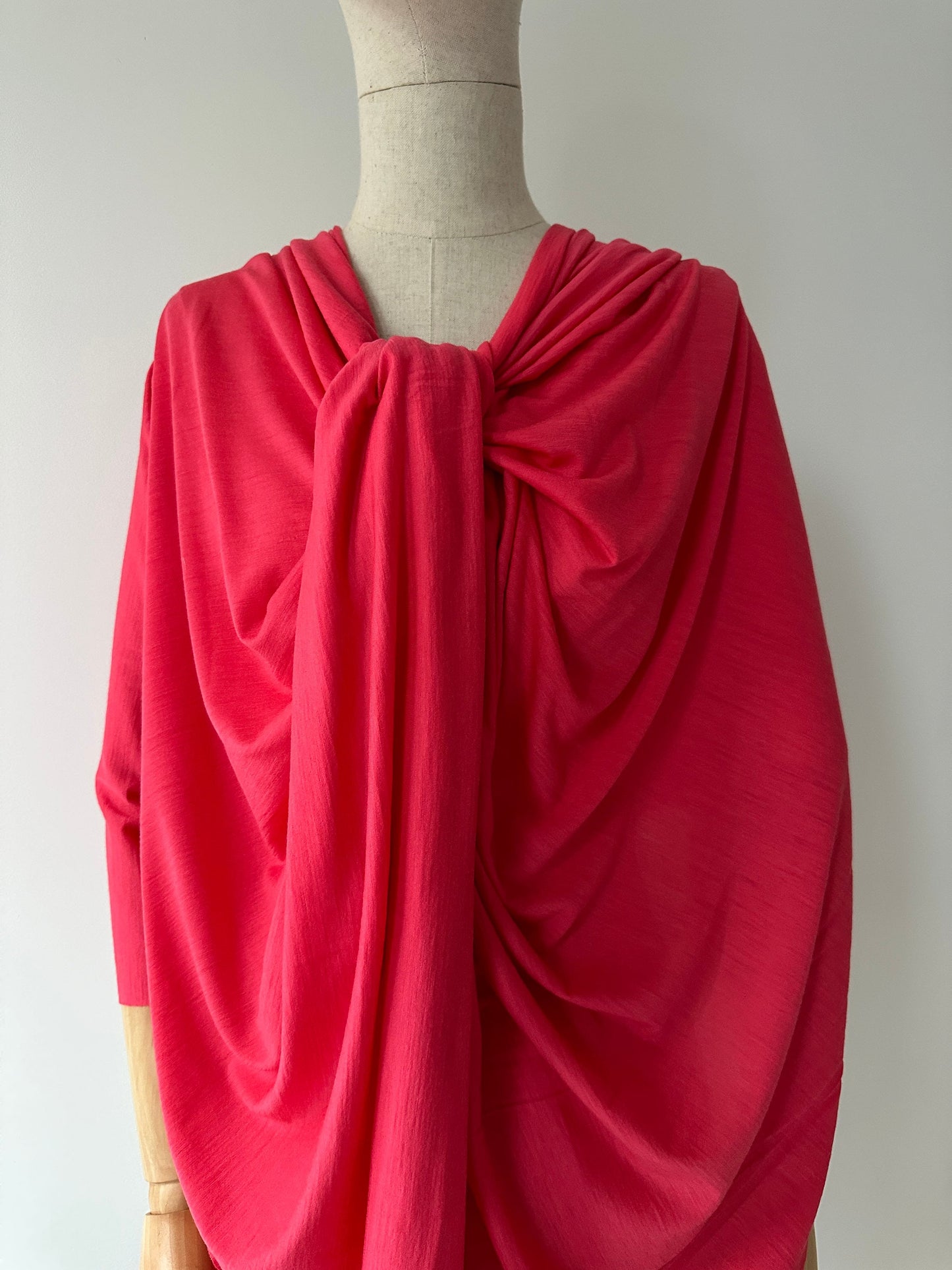 Rich geranium hue merino wool styled as a women's dress.