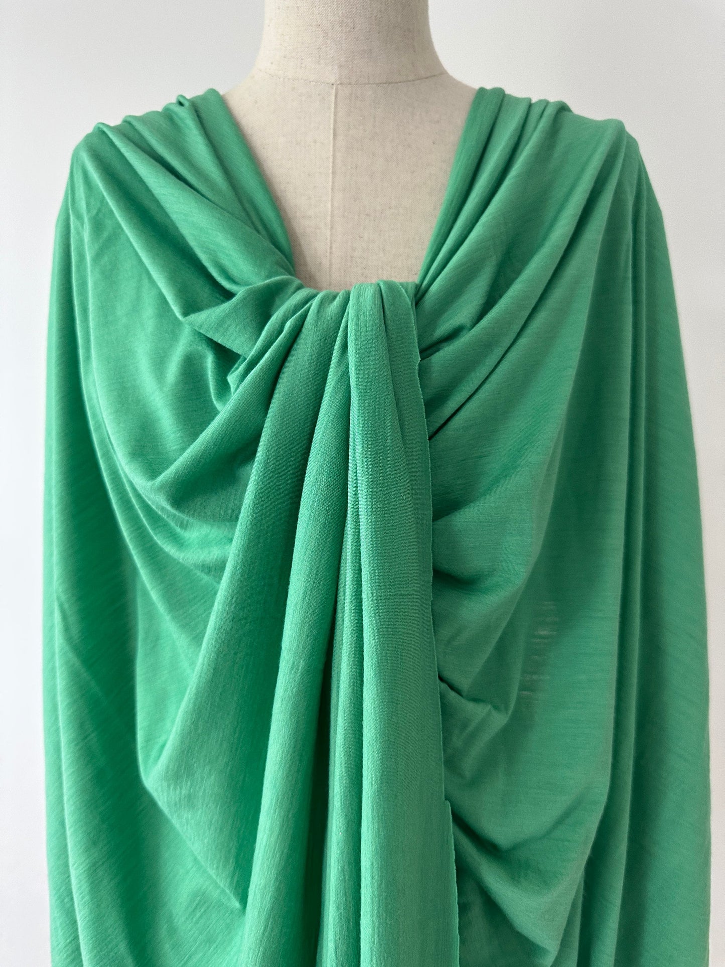 Fine micron merino wool styled and layered on dress form.