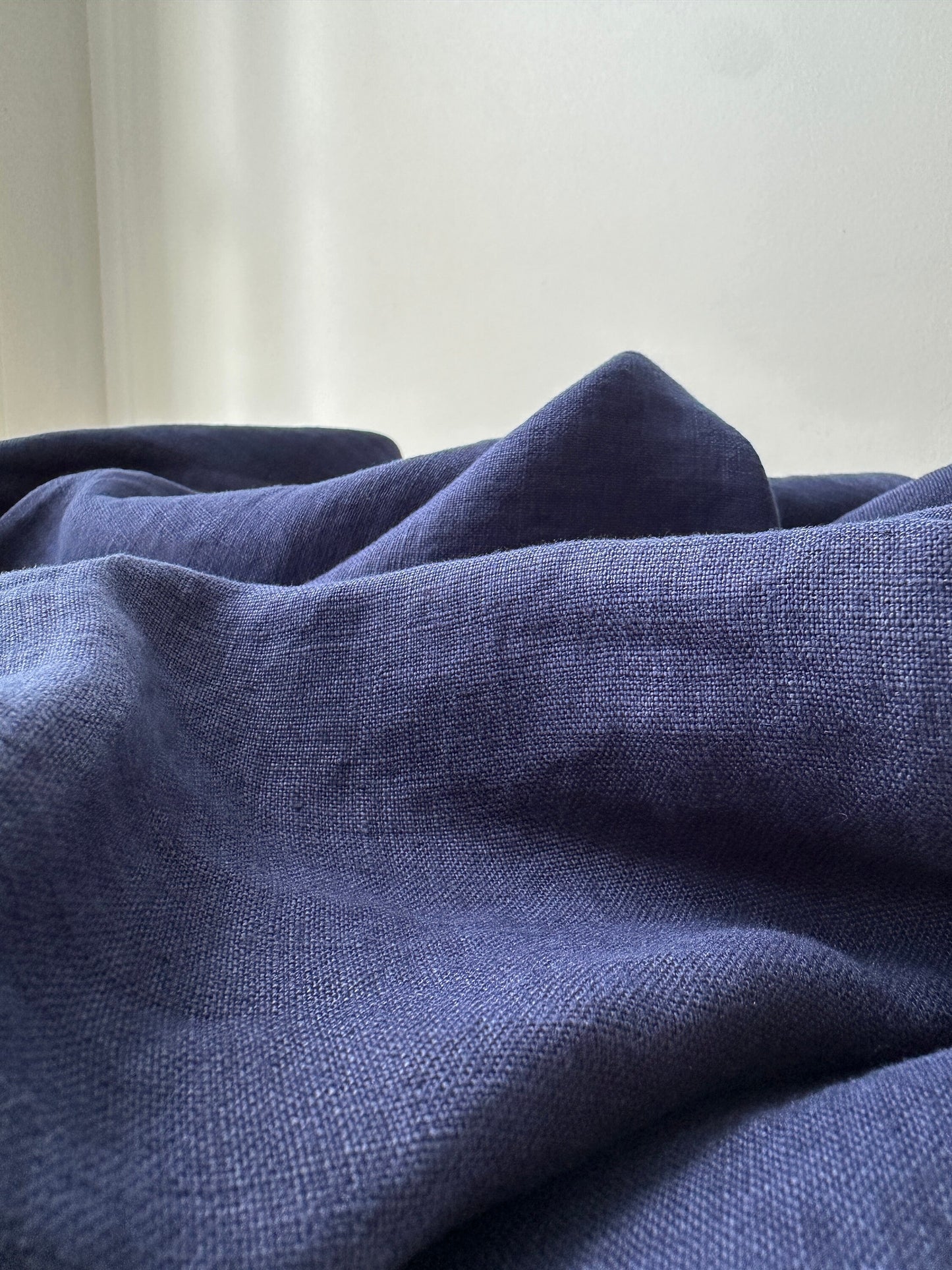 batik blue linen fabric texture in natural light showing color depth