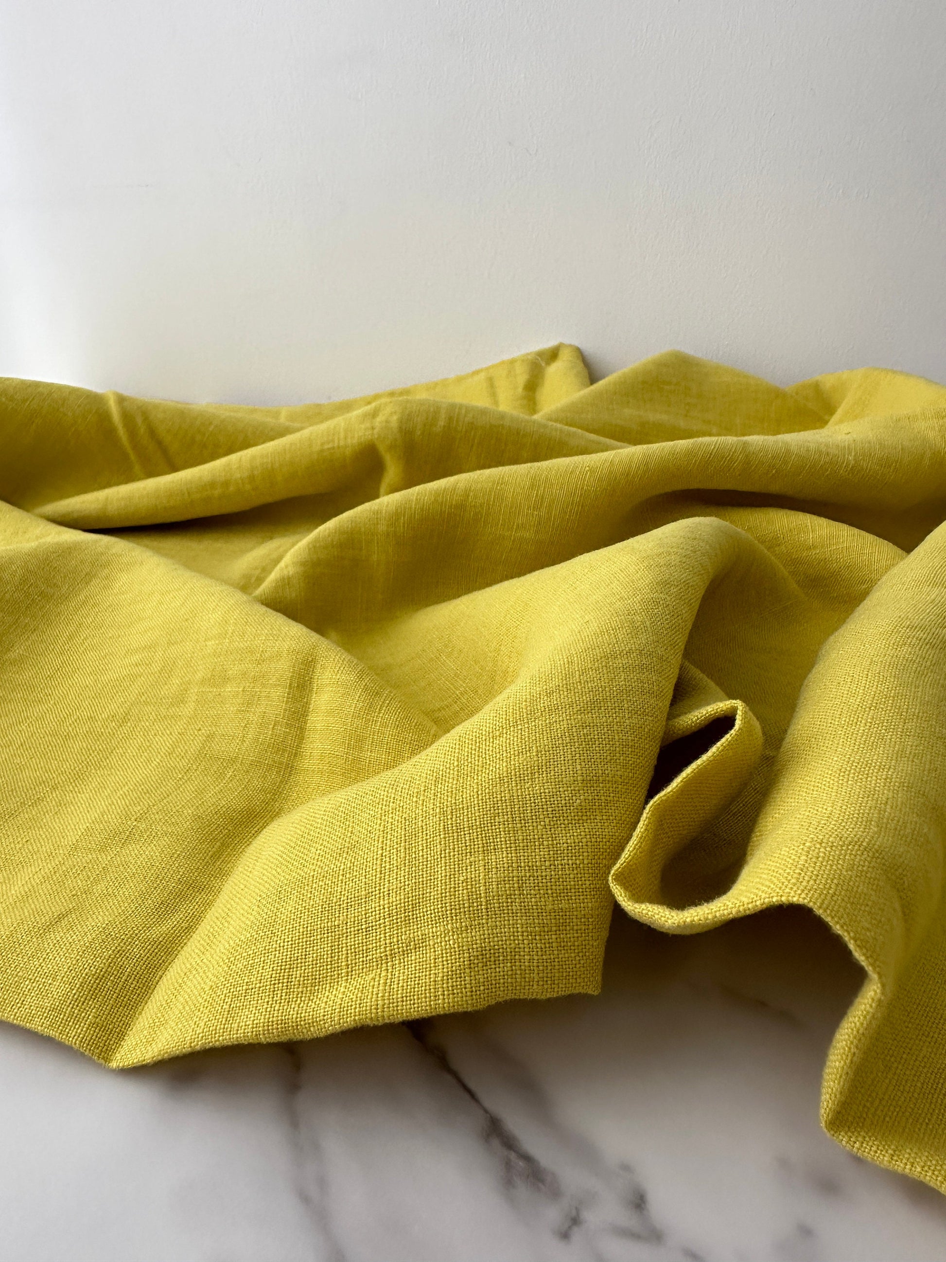 Linen fabric draped in lively citron color