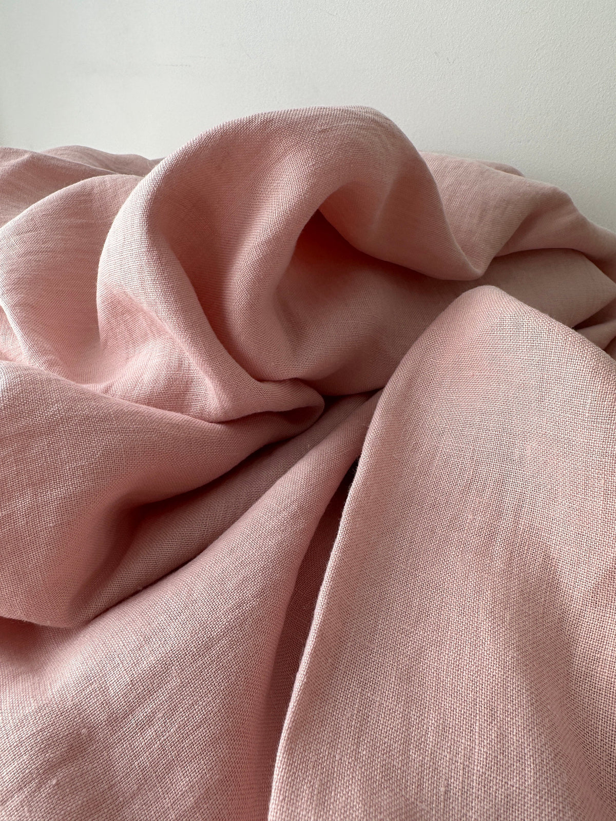blush pink linen fabric detail showing slub and weave texture