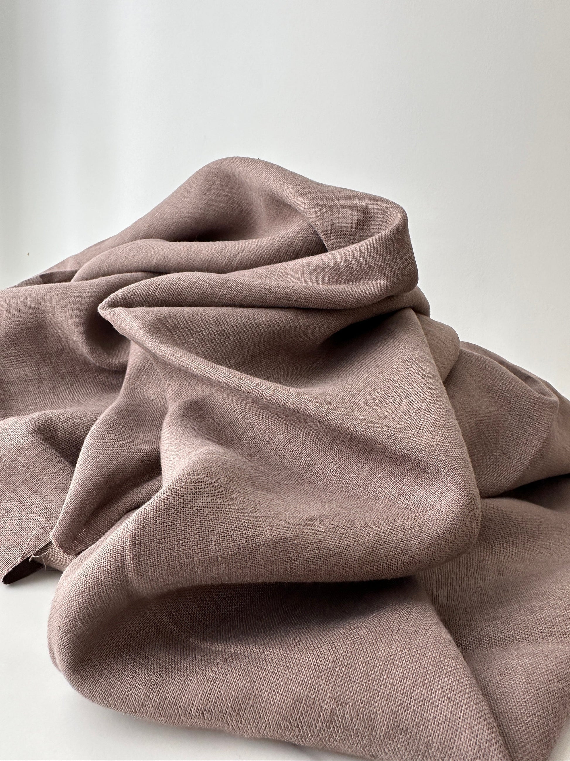 taupe linen fabric folded in natural lighting 