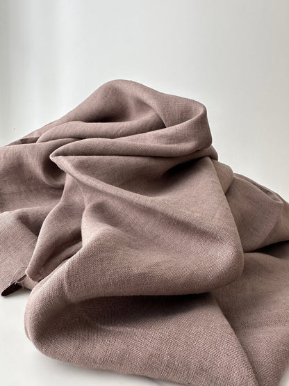 taupe linen fabric folded in natural lighting 