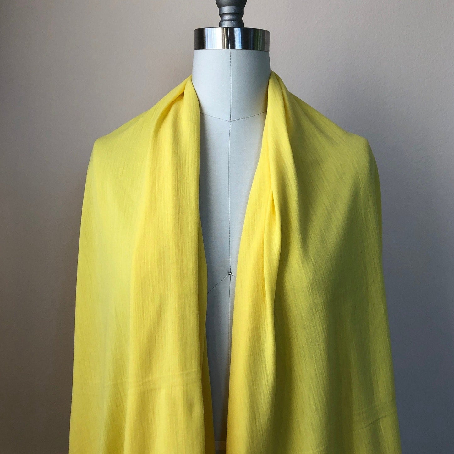 100% Merino wool lightweight jersey fabric sold by the yard, available in Mimosa Yellow.