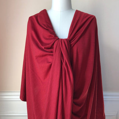 Stretch merino wool jersey knit fabric in elegant red color.