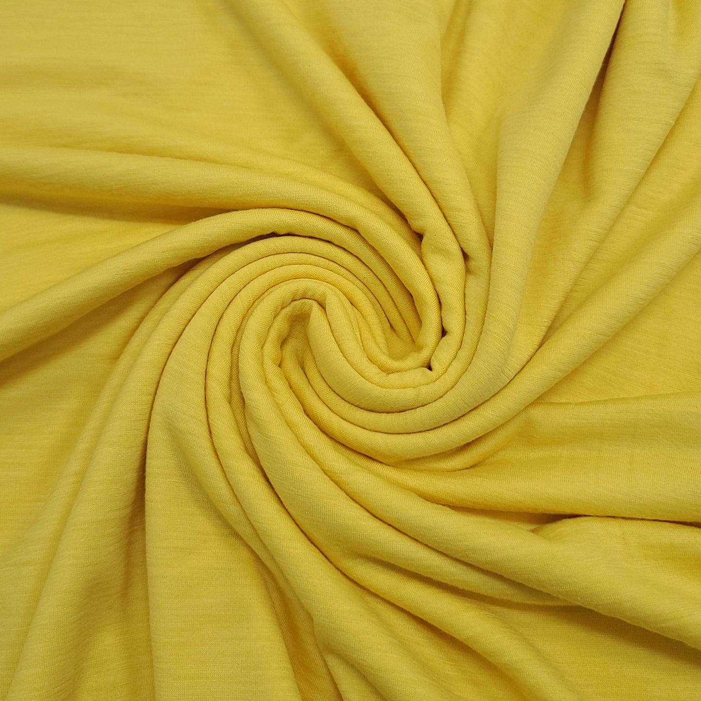 Merino Wool plain Jersey fabric styled in swirled shape. 