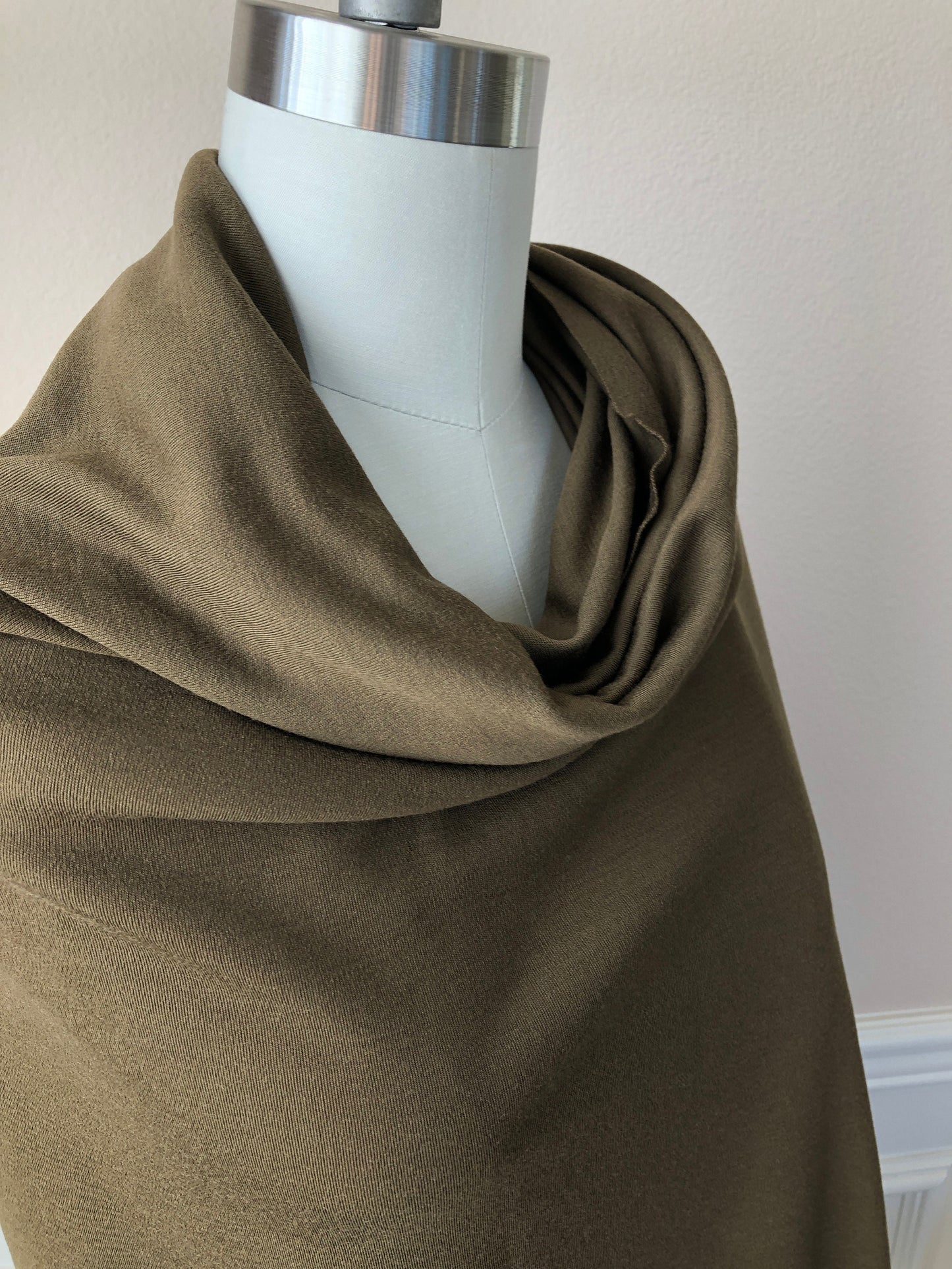 Merino wool fabric in brown color with green undertone.