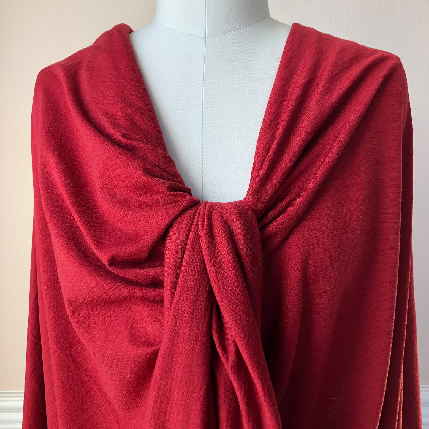 Close view of elegant red color merino wool fabric.