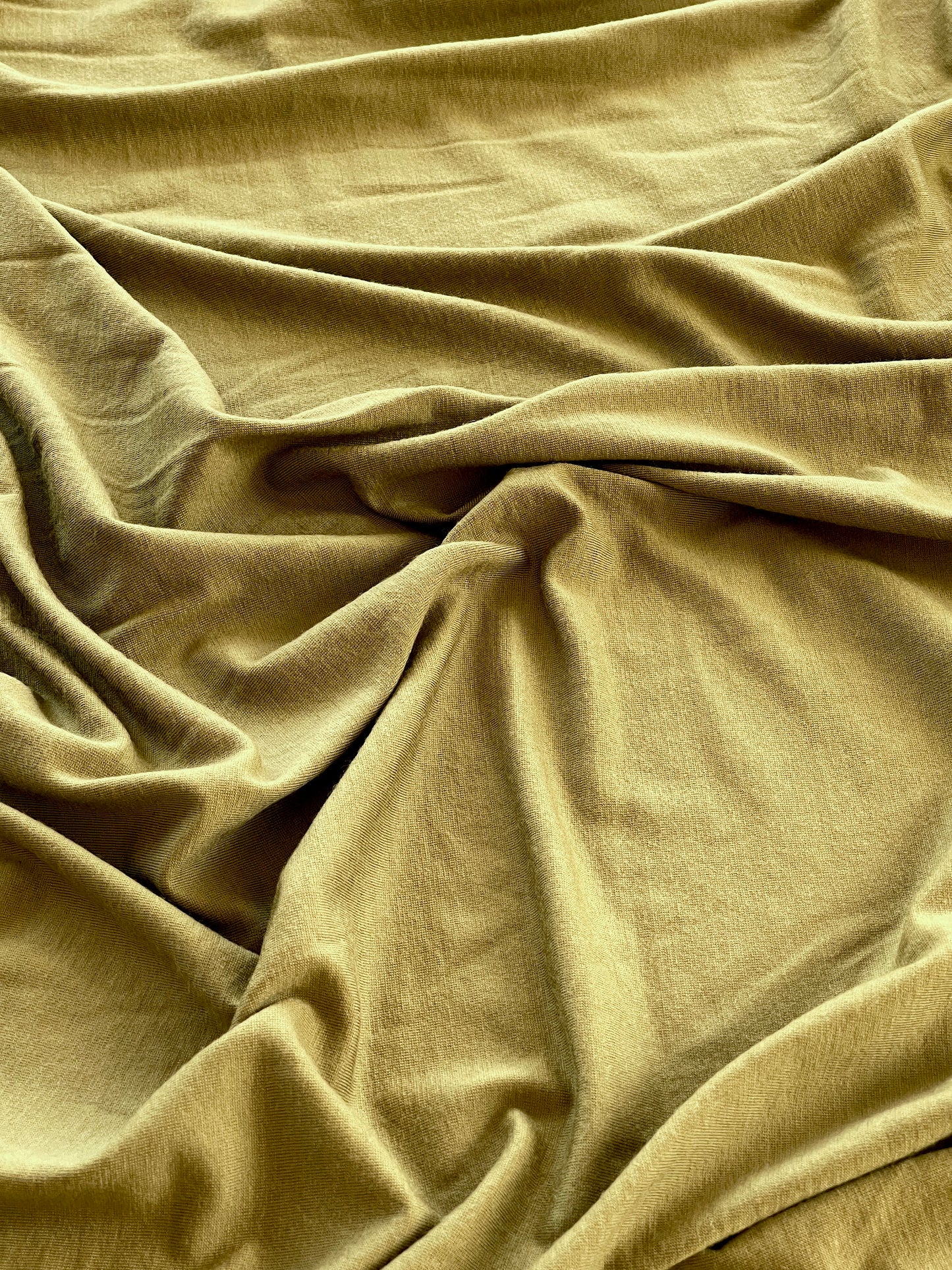 Eco-friendly merino wool material in army green.