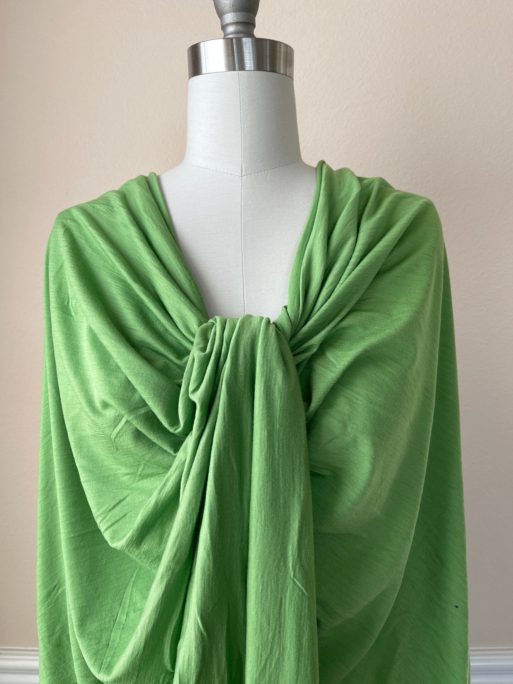 Soft merino wool fabric draped as a dress on female mannequin.