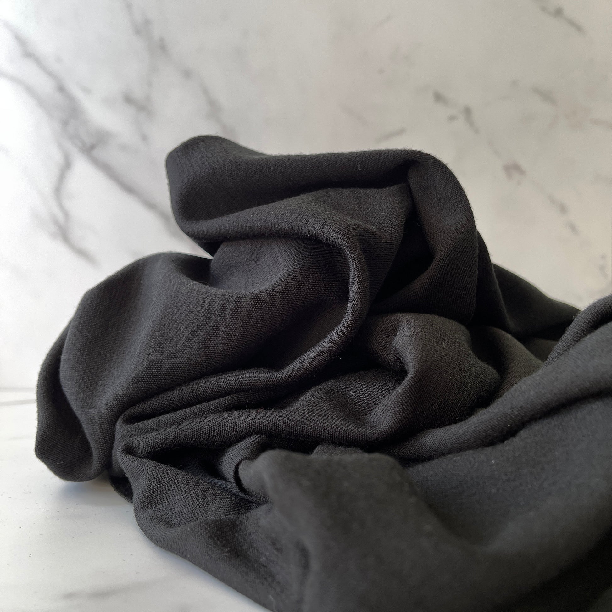 Renewable merino wool fabric in true black color.