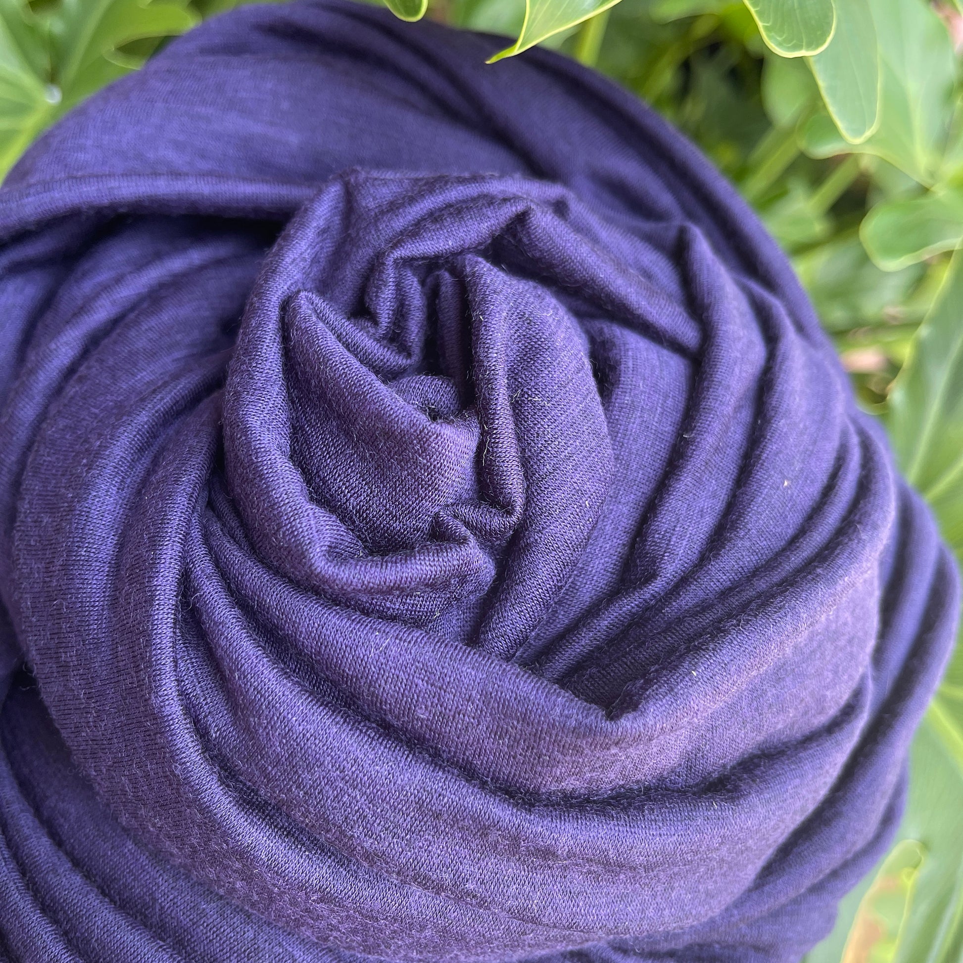 Black and blue heather effect merino wool showing natural luster.