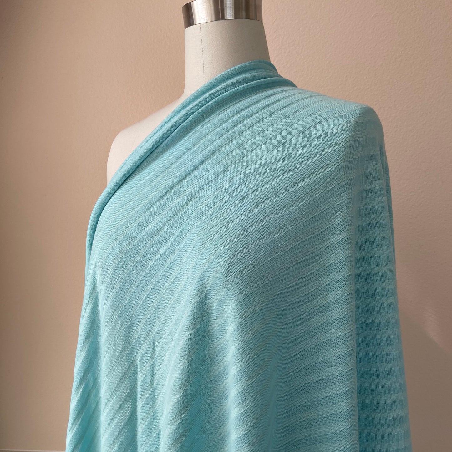 Stylish merino wool stripe jersey fabric in eye soothing blue color.