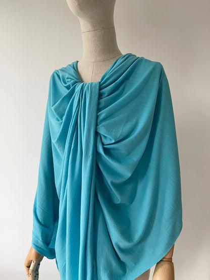 Women dress form with blue soft merino wool fabric draped as a blouse.