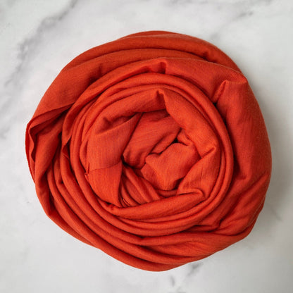 Merino wool jersey in crimson orange hue very close to fierce  red color. 