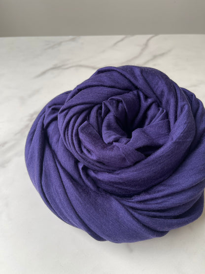 A yard of merino wool styled on a marble table.