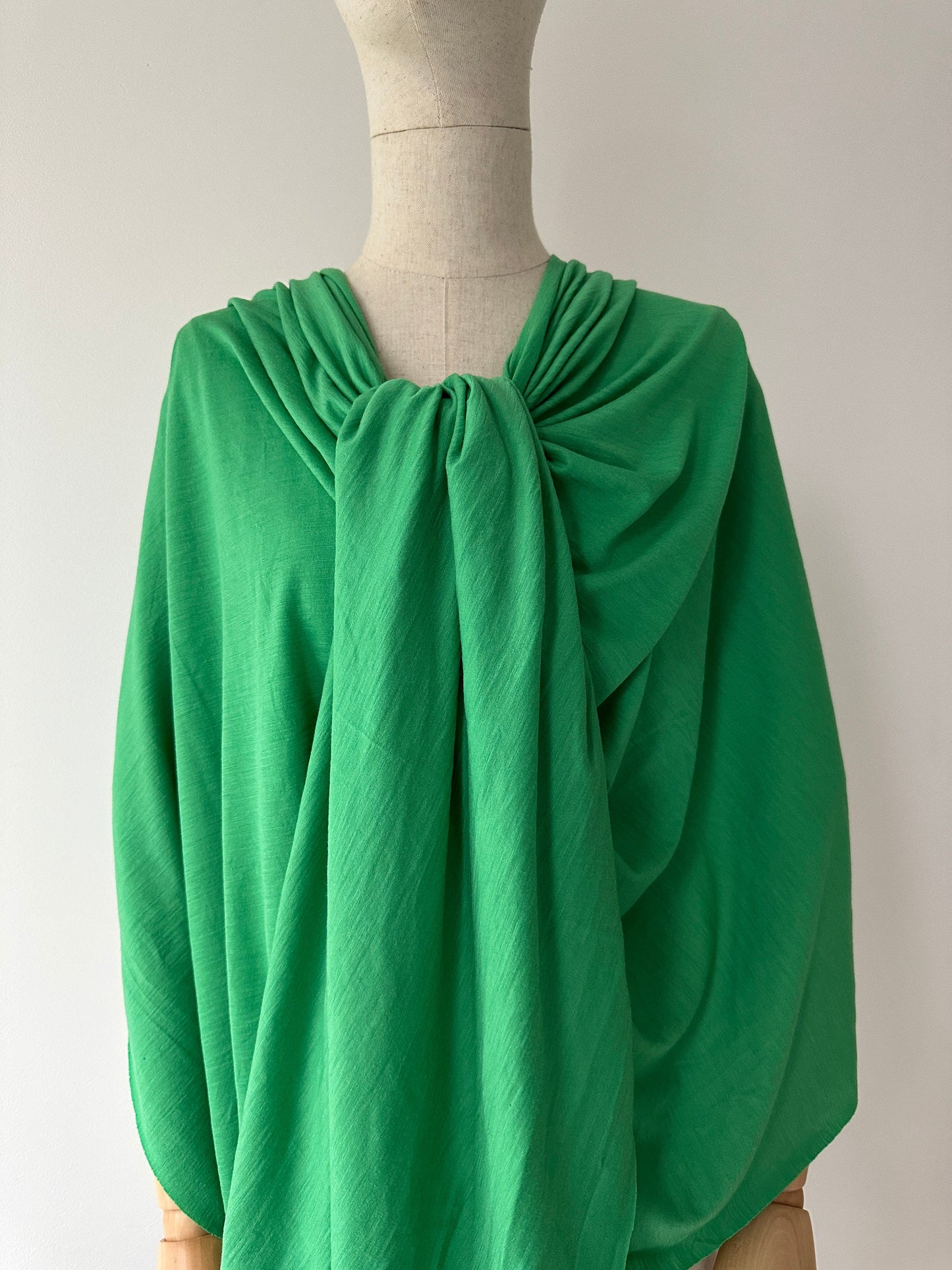 Sprouts Green color fine micron merino wool fabric on mannequin.