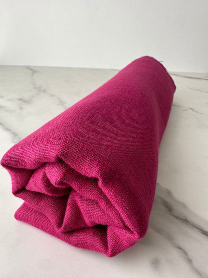 magenta linen fabric rolled and look from far