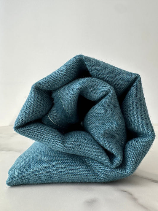 modern teal blue fabric rolled up