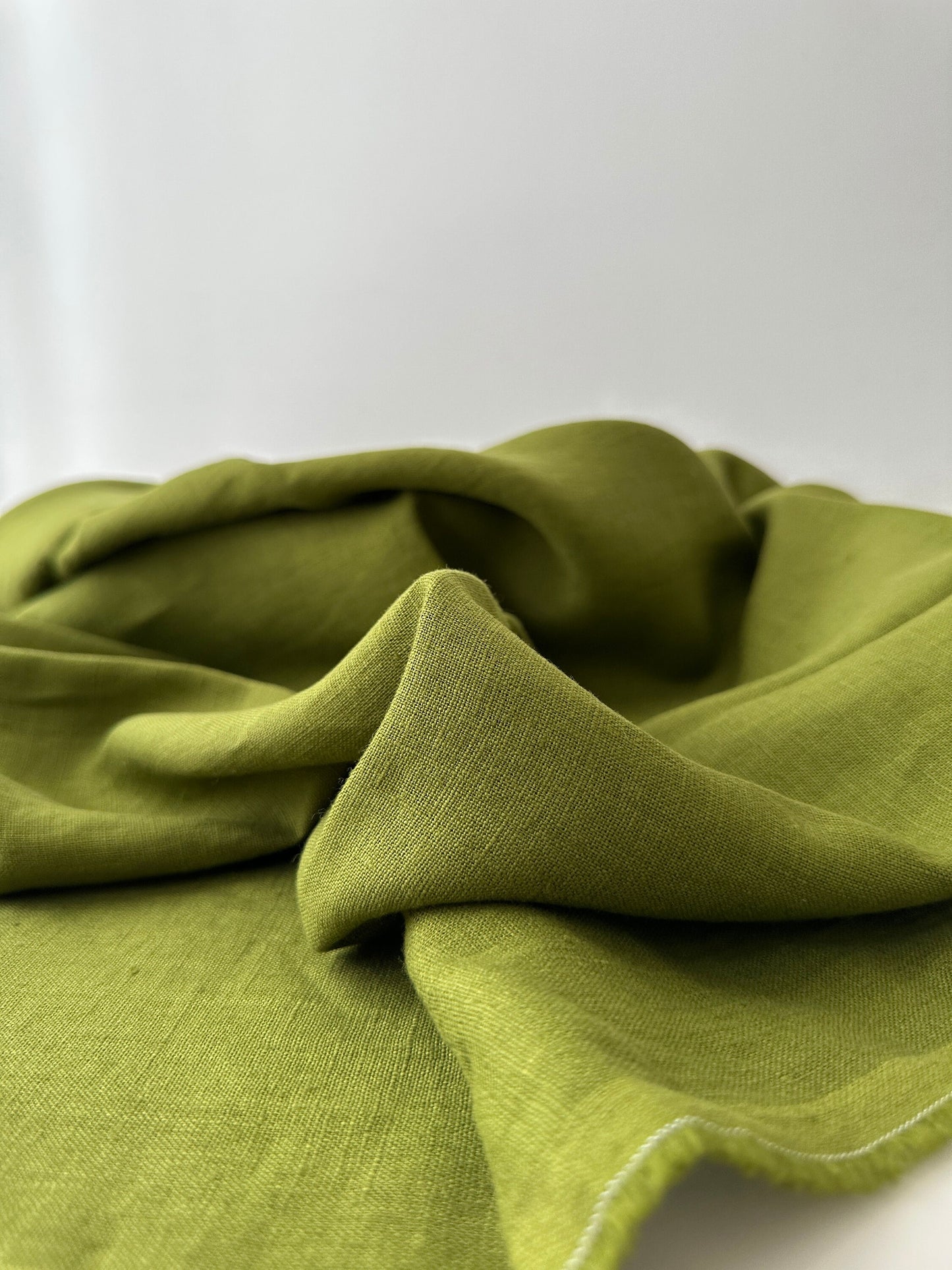 olive green linen fabric slub texture close up