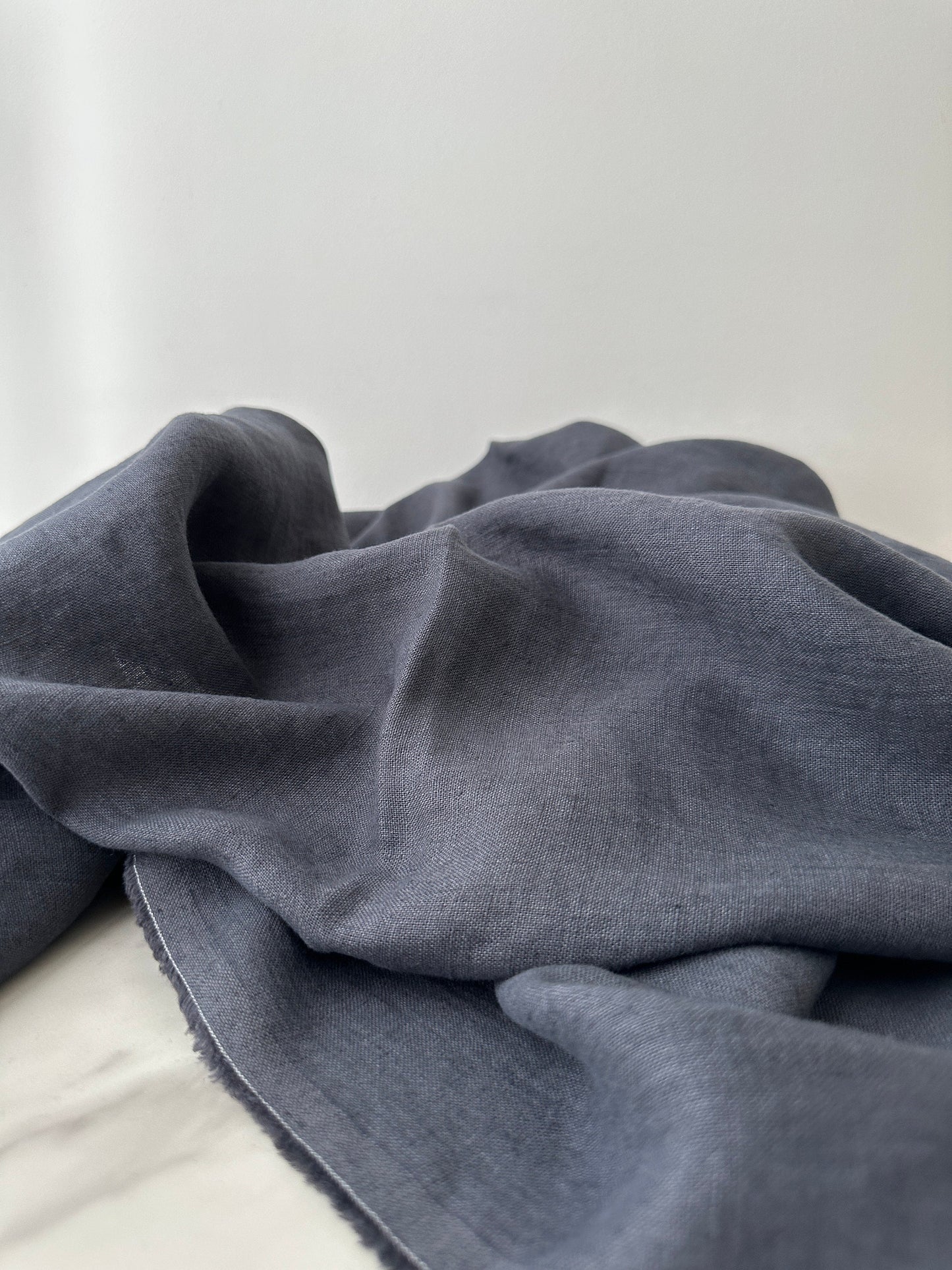 washed and soften smoke gray linen fabric in natural light indoor