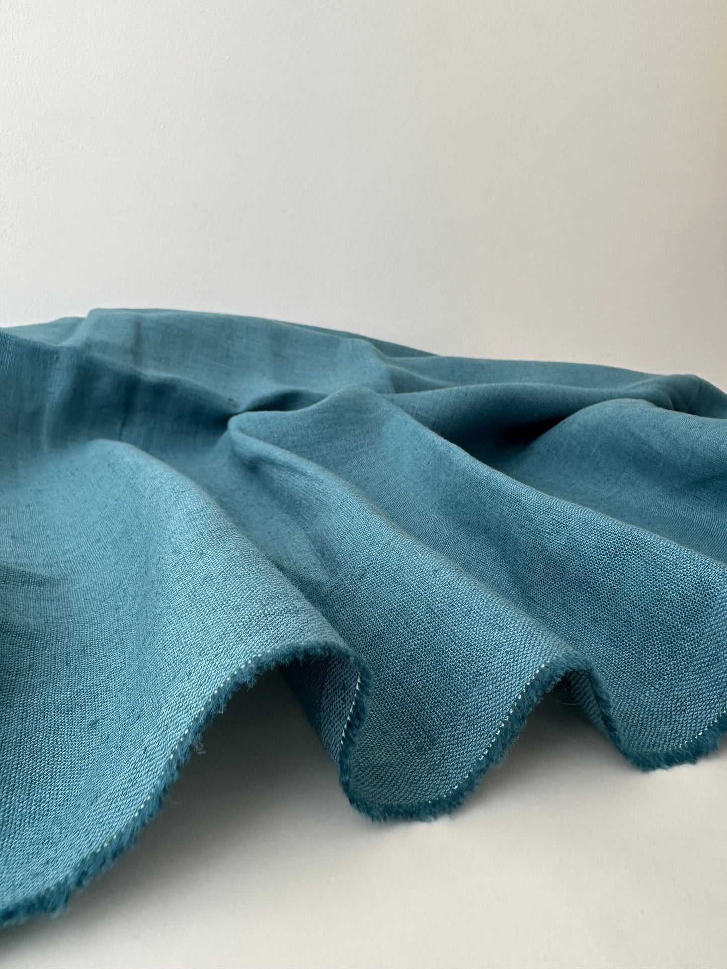 teal blue linen on table presenting plain weave texture