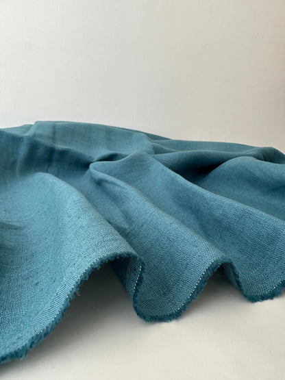 teal blue linen on table presenting plain weave texture
