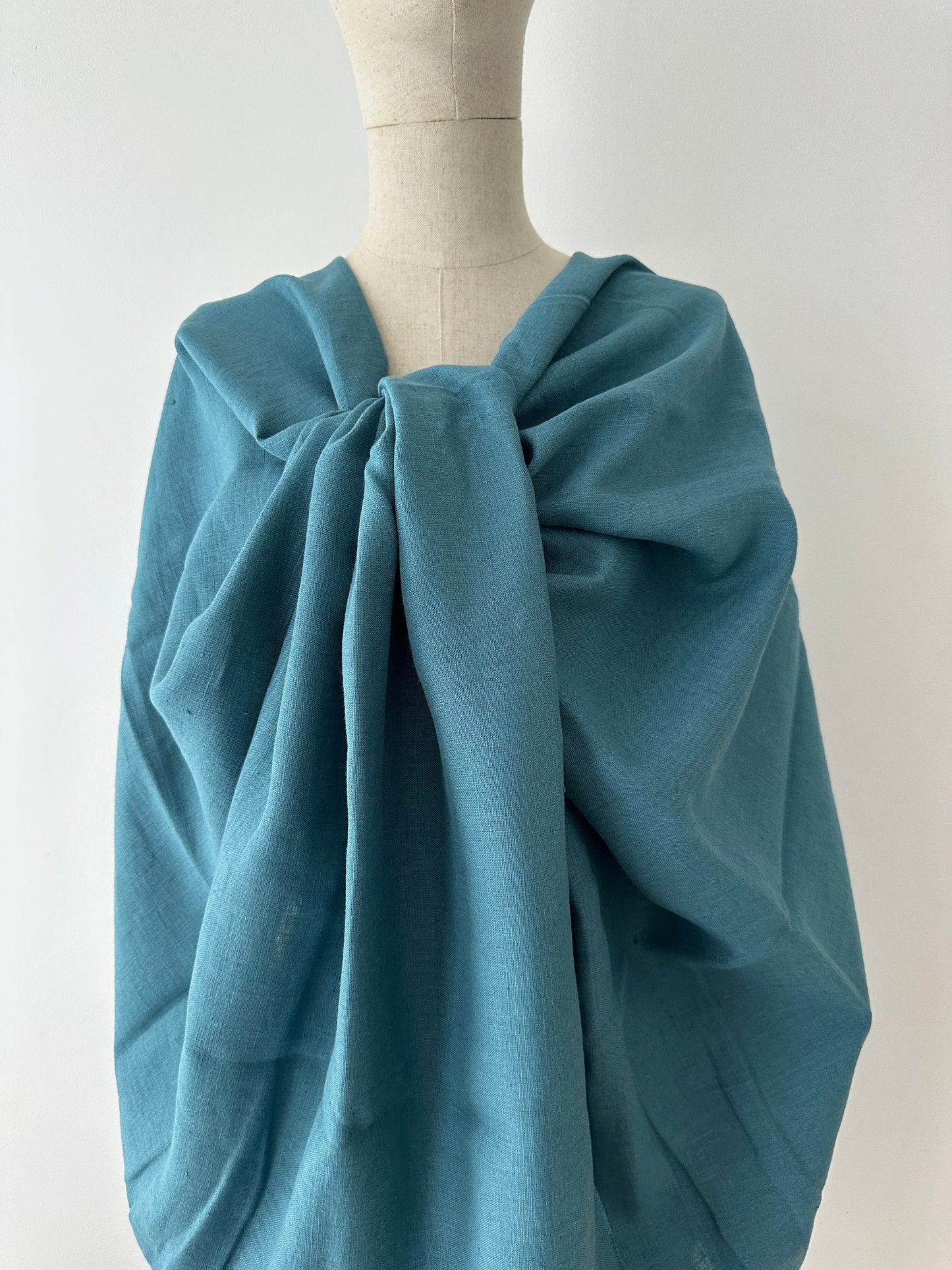 teal blue linen textile show on model to mimic spring and summer dress