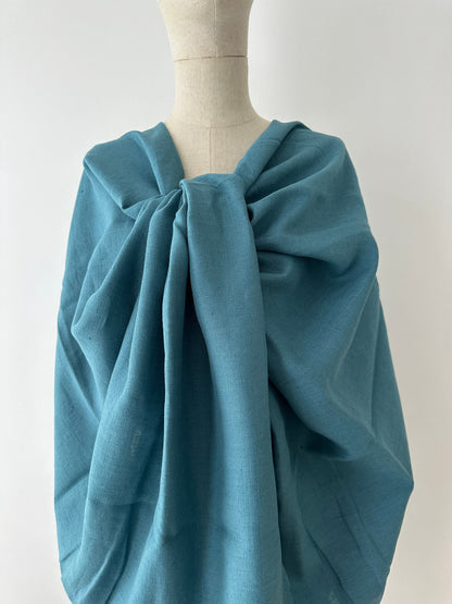 teal blue linen textile show on model to mimic spring and summer dress