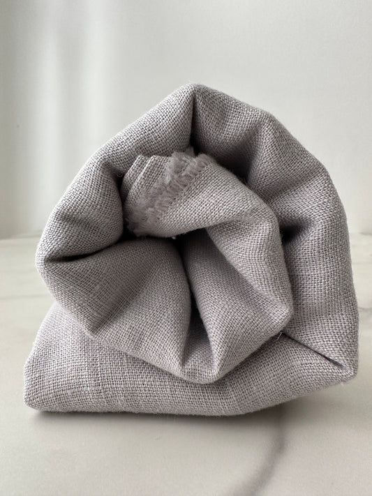 dove gray linen fabric rolled for presentation